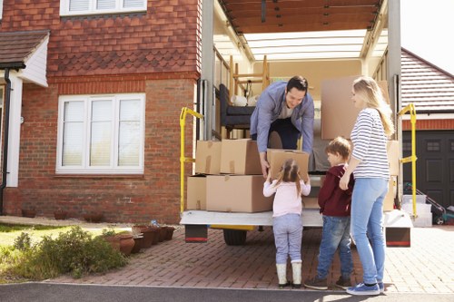 Removal team loading boxes and furniture for a house move