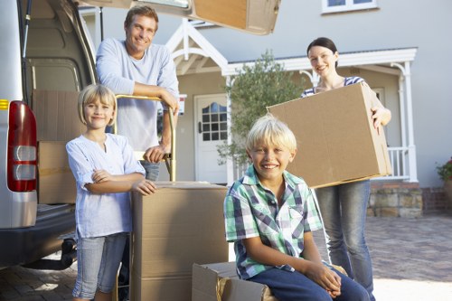 Boxes and household items being loaded into a van for transport