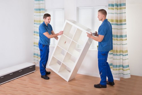 Staff handling fragile items with careful lifting and protection