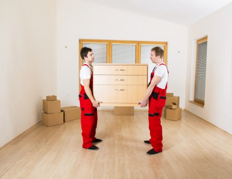 Workers checking moving equipment and securing heavy items