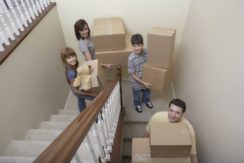 Removal workers loading furniture carefully into a van